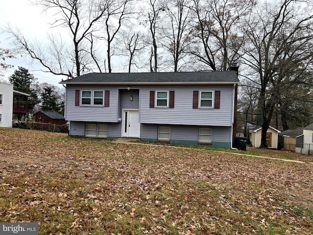 raised ranch featuring a storage shed