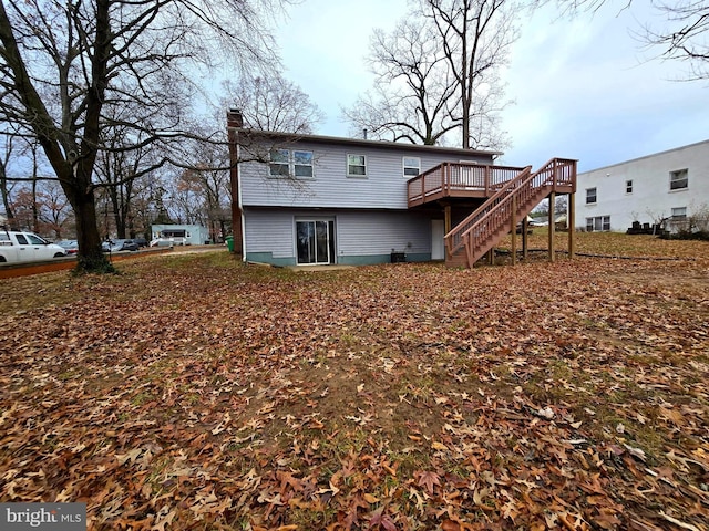 back of property with a wooden deck