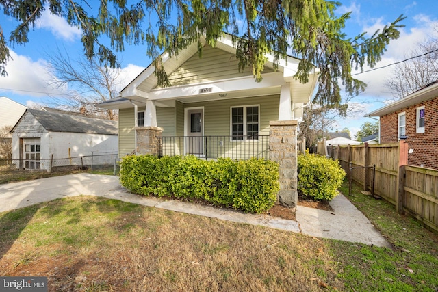 bungalow with a front yard and a porch