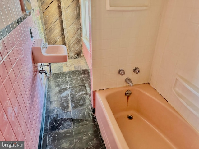 bathroom featuring a tub and sink