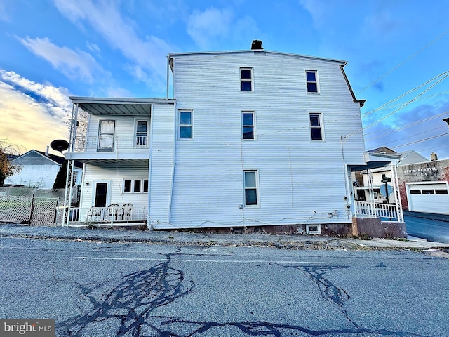 view of side of property with a porch