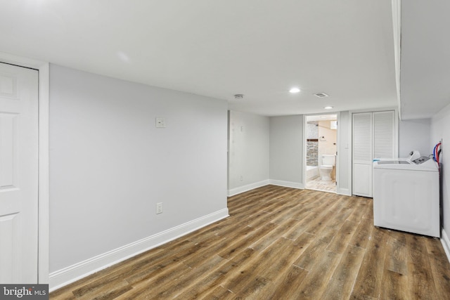 finished below grade area featuring recessed lighting, baseboards, and wood finished floors