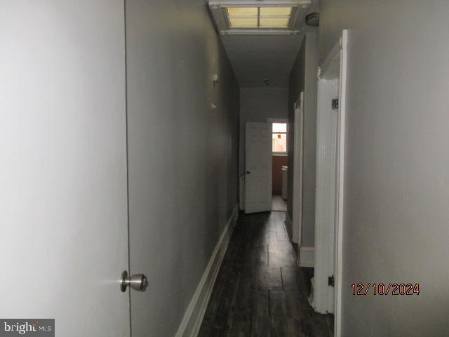 hallway featuring dark hardwood / wood-style flooring