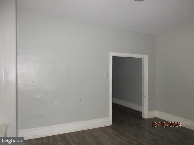 empty room with dark hardwood / wood-style floors