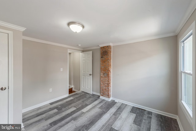 unfurnished room with wood-type flooring, ornamental molding, and a healthy amount of sunlight