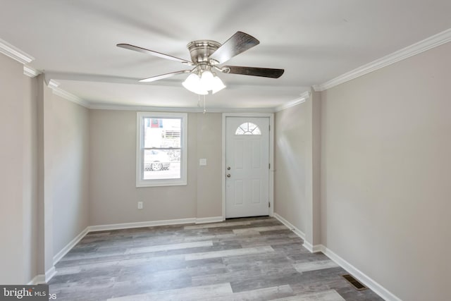 foyer with ceiling fan, light wood-type flooring, and crown molding