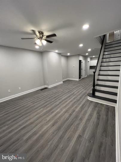 basement featuring dark hardwood / wood-style floors and ceiling fan