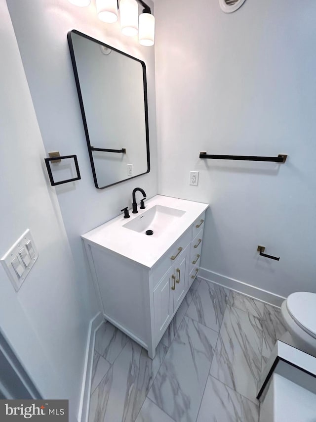 bathroom featuring vanity and toilet