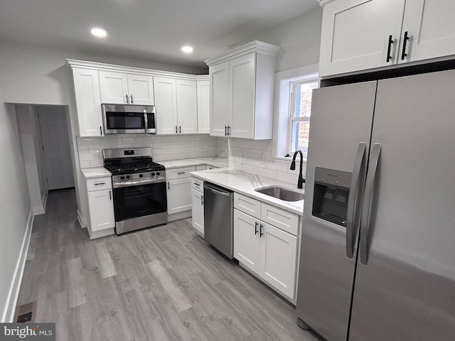 kitchen with white cabinets, sink, and stainless steel appliances