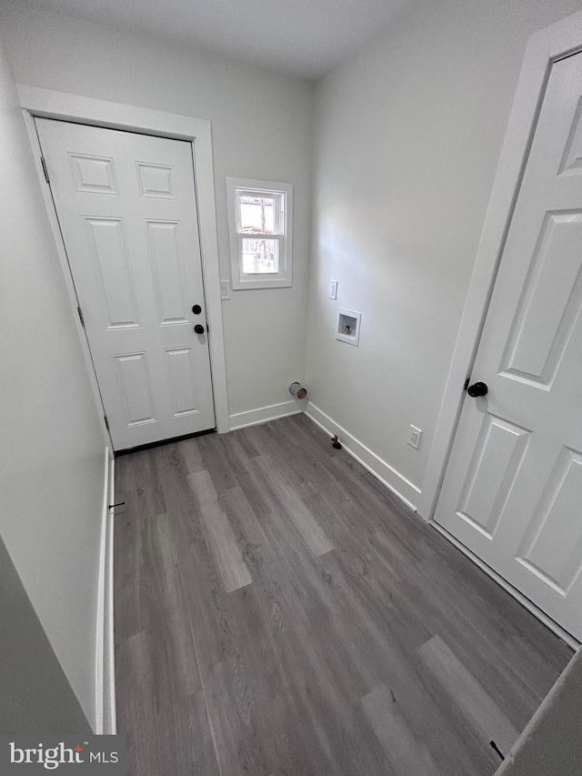 clothes washing area featuring hookup for a washing machine and hardwood / wood-style flooring