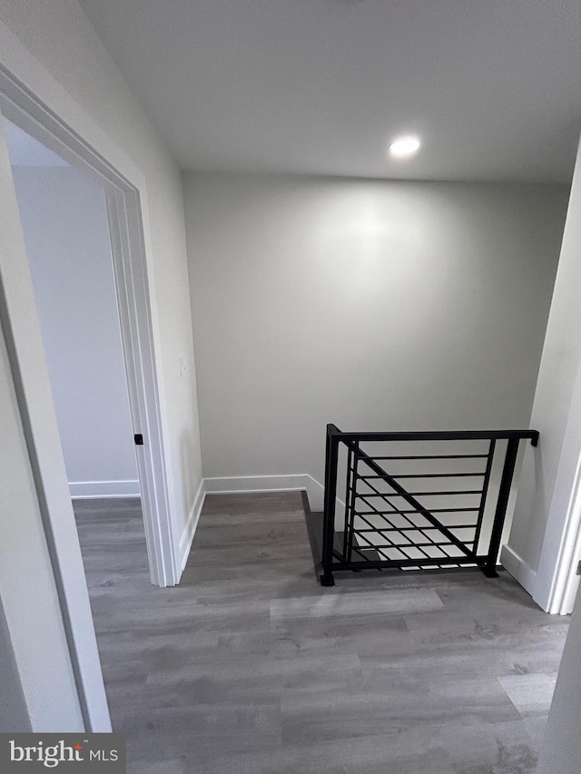 staircase with hardwood / wood-style flooring