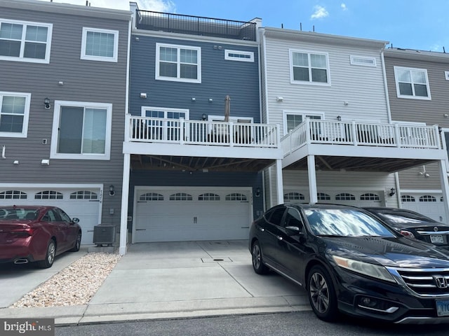 back of house featuring a garage and central air condition unit