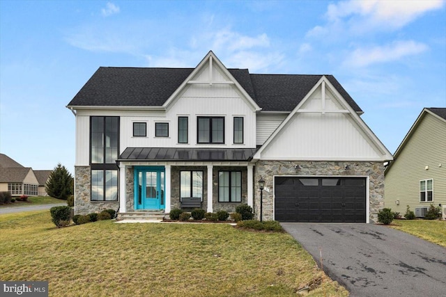 modern inspired farmhouse featuring a front yard and a garage