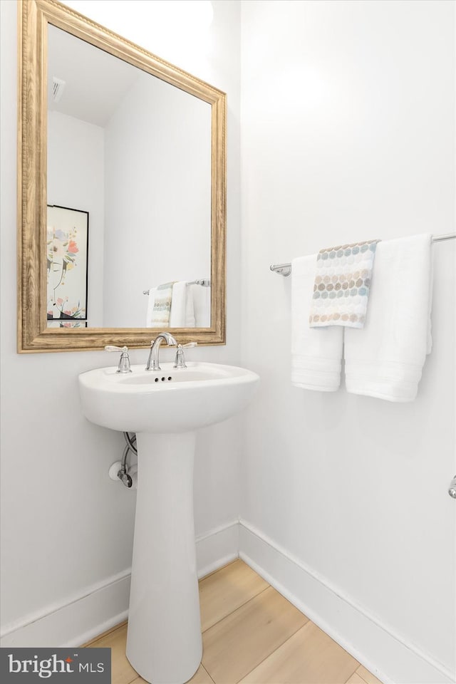 bathroom with hardwood / wood-style flooring