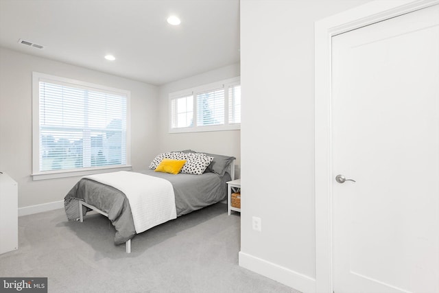 bedroom featuring light carpet