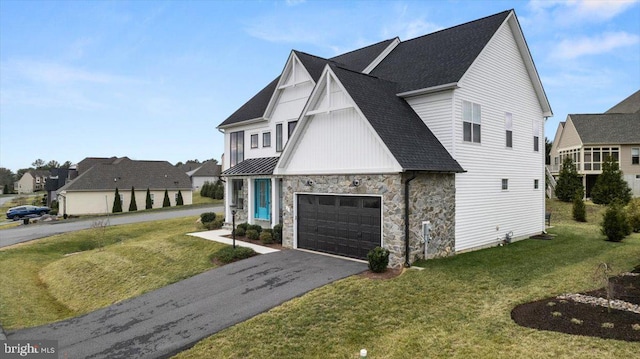 modern inspired farmhouse with a front yard and a garage