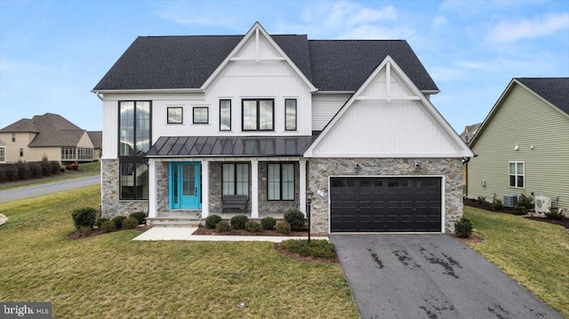 modern inspired farmhouse featuring a front lawn, central AC unit, and a garage