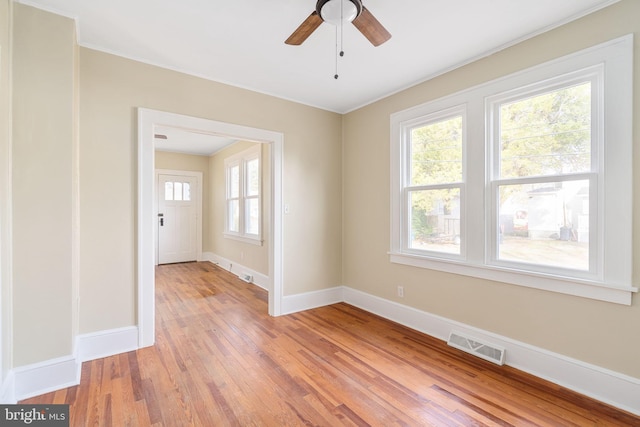 unfurnished room featuring light hardwood / wood-style floors, ceiling fan, and ornamental molding