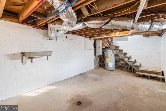 basement featuring electric panel and electric water heater