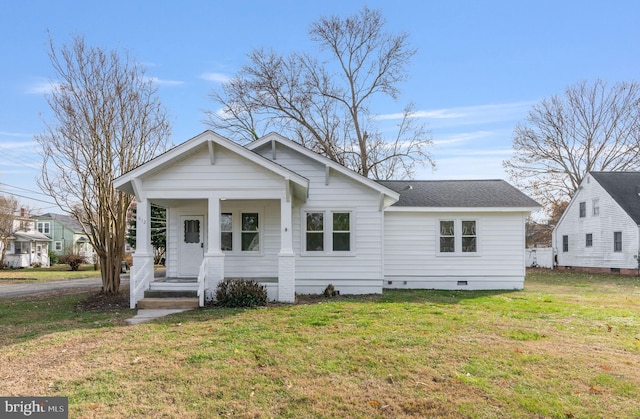 view of front of house with a front yard and a porch