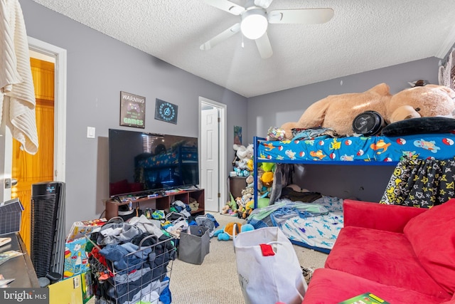 bedroom featuring a textured ceiling, ceiling fan, and carpet flooring