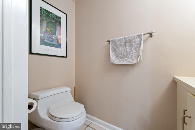 bathroom featuring toilet, vanity, and tile patterned flooring