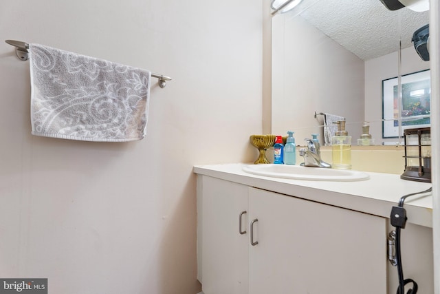 bathroom with vanity and a textured ceiling