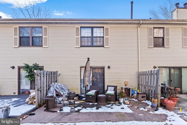 view of snow covered rear of property