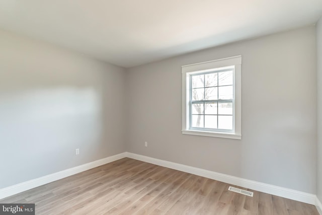 spare room with light wood-type flooring