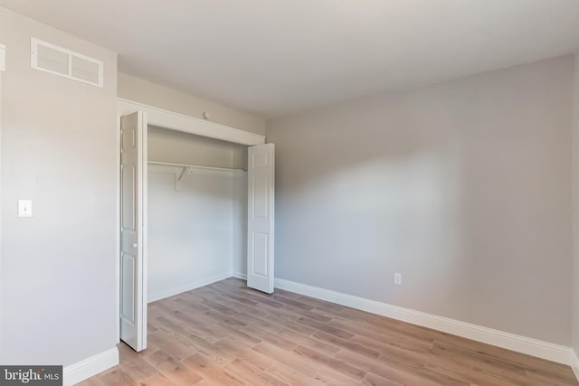 unfurnished bedroom with light hardwood / wood-style floors and a closet