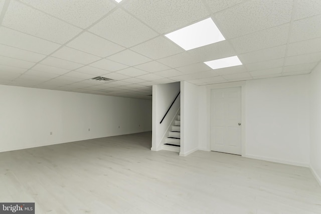 basement with a paneled ceiling