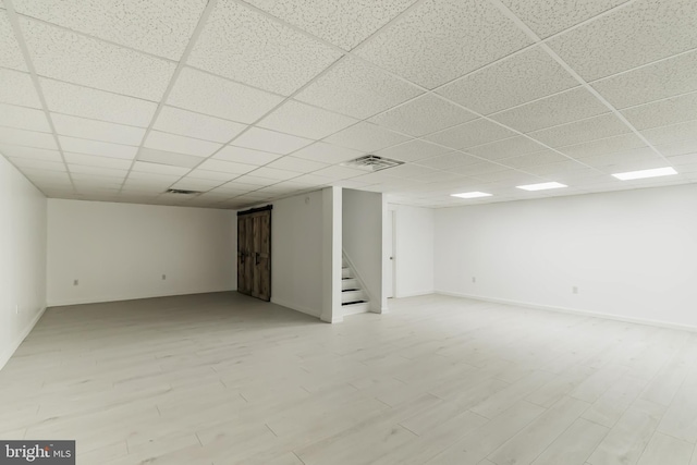 basement featuring a drop ceiling