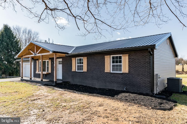 single story home featuring central AC, covered porch, and a garage