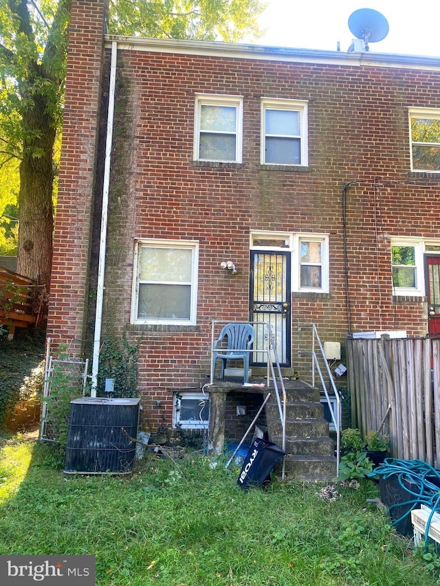 rear view of house with central AC unit