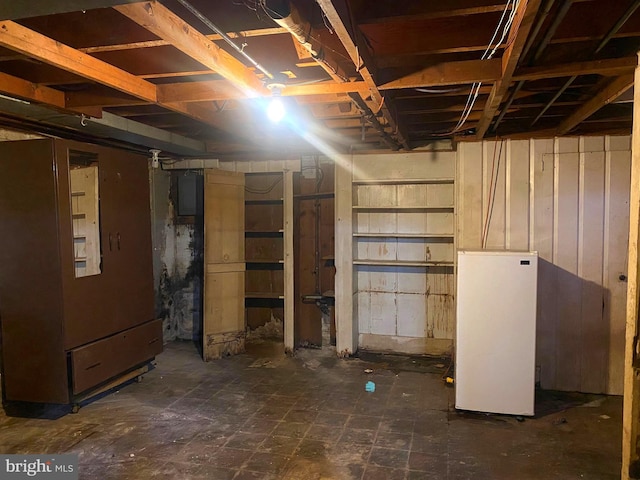 basement featuring white refrigerator