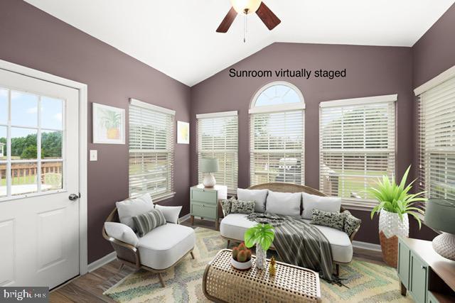 interior space featuring ceiling fan, hardwood / wood-style floors, a healthy amount of sunlight, and lofted ceiling