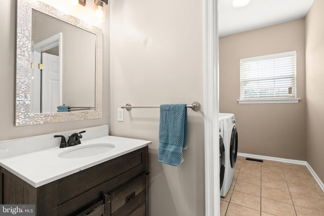 bathroom with tile patterned floors, vanity, and independent washer and dryer