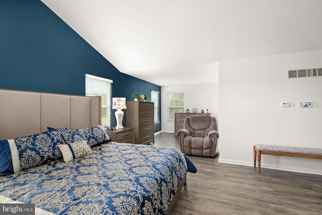 bedroom featuring dark hardwood / wood-style flooring and lofted ceiling