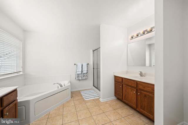 bathroom featuring independent shower and bath, tile patterned flooring, and vanity