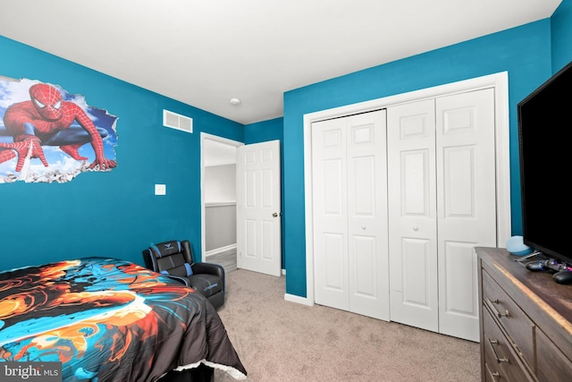 bedroom featuring light colored carpet and a closet