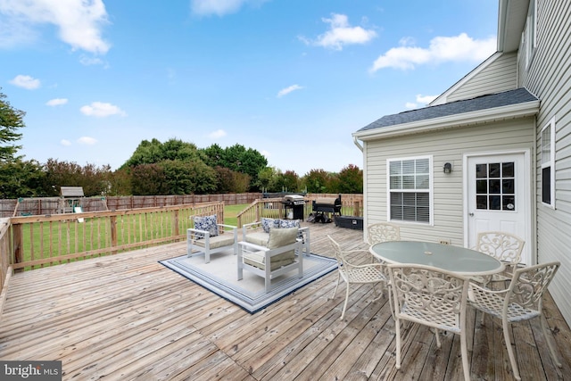 wooden deck featuring a grill and an outdoor living space