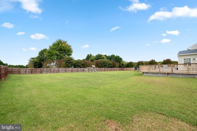 view of yard featuring a playground and a deck