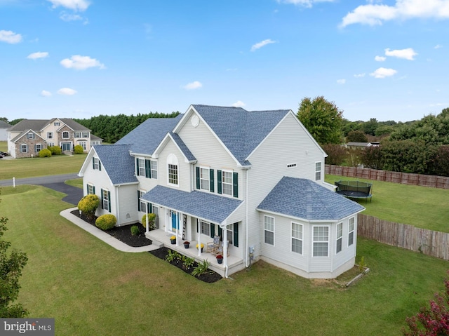 view of front of home featuring a front lawn and a trampoline