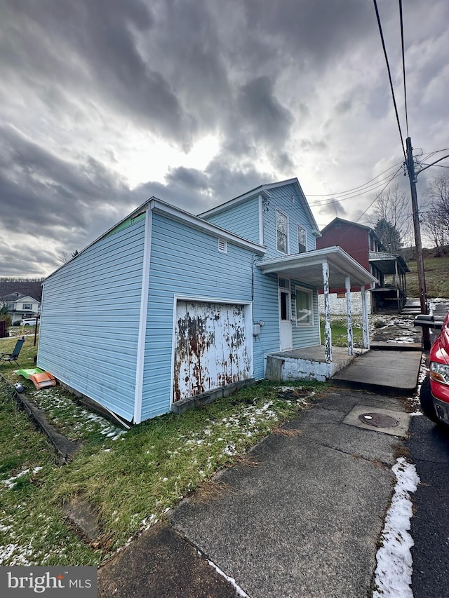 view of side of property featuring covered porch