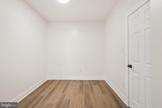 unfurnished room with wood-type flooring