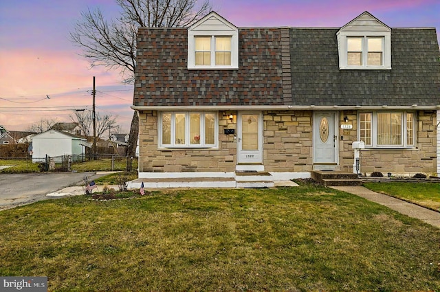 cape cod-style house featuring a yard