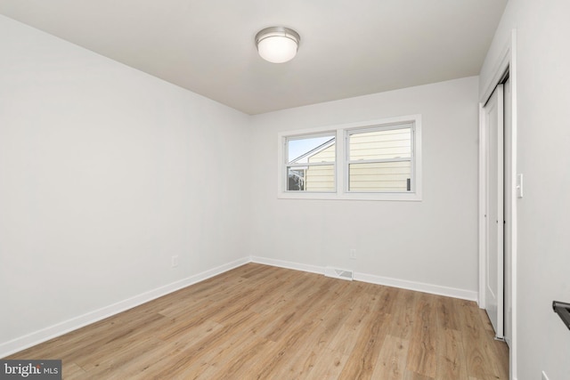 unfurnished bedroom featuring a closet and light hardwood / wood-style flooring