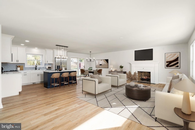 living room featuring light hardwood / wood-style flooring and a healthy amount of sunlight