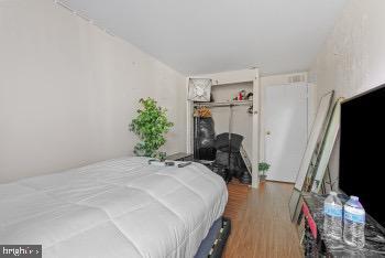 bedroom featuring hardwood / wood-style flooring and a closet