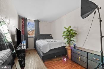 bedroom with hardwood / wood-style flooring